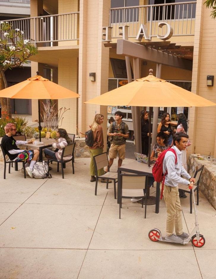 Students talk and work outside the Pit Stop Cafe